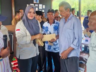 Seorang perwakilan PT Bumi Laksamana Jaya menyerahkan bantuan tunai kepada korban kebakaran di Desa Bukit Batu, Bengkalis.