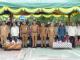 Pejabat Pemkab Bengkalis berdiri di bawah tenda berwarna hijau-kuning saat pembukaan Gebyar Fisika ke-18 di SMAN 2 Bengkalis.